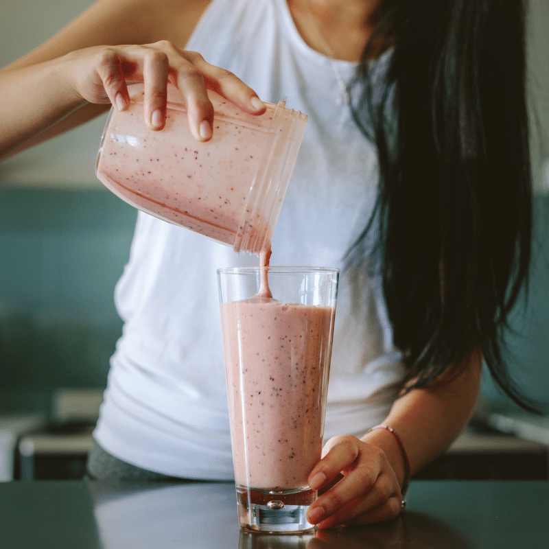 Image of a woman making a smoothie with sea moss gel.